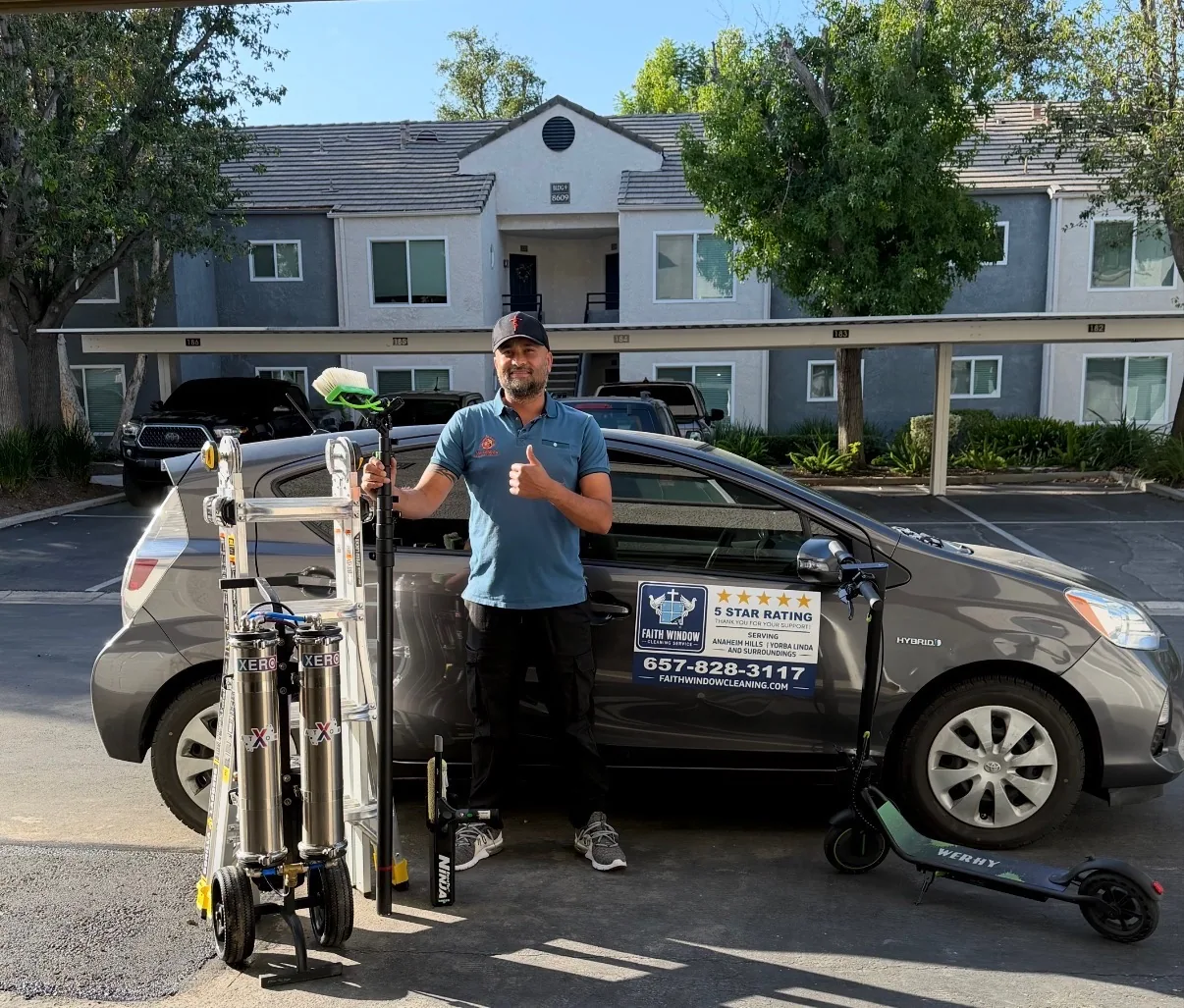 Owner of Faith Window Cleaning ready on the job with the Faith truck, scrubber, and water-fed pole equipment